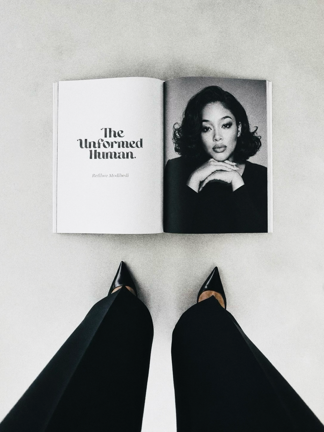 An open copy of The Unformed Human viewed from above.